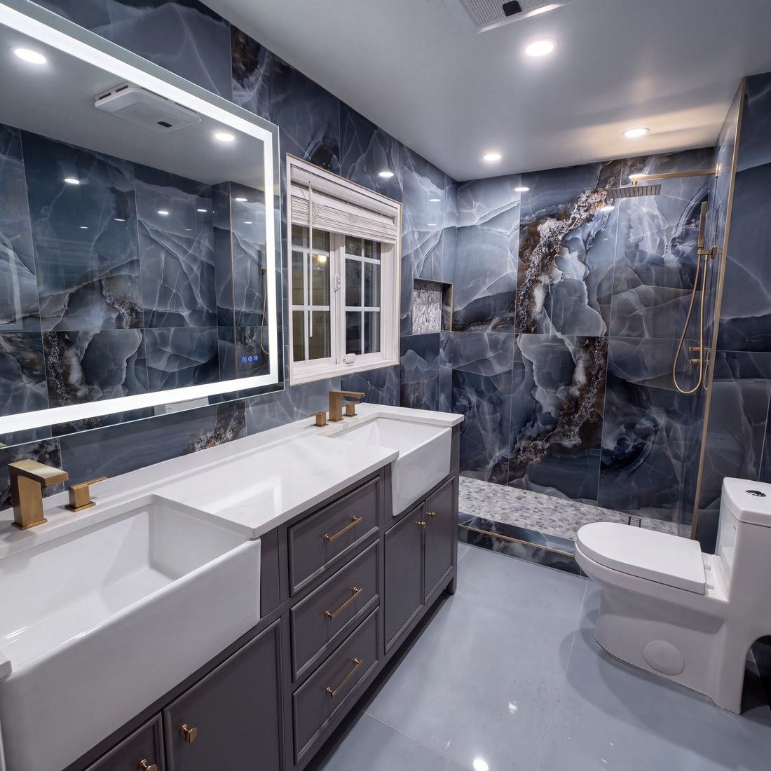 Bathroom with dramatic blue marble tile walls, walk-in shower, and brass fixtures by Home Tile Designs